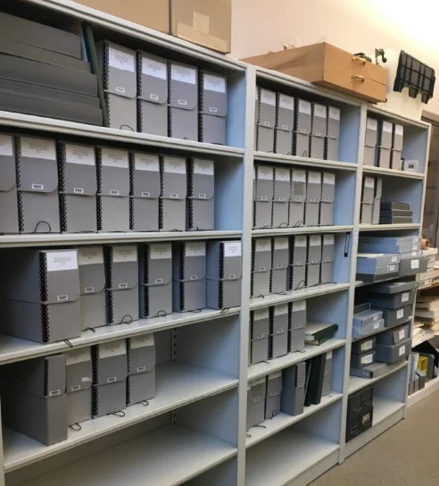 The entire Wellesley Hills Collection sits in long boxes on shelves in the library workroom. 