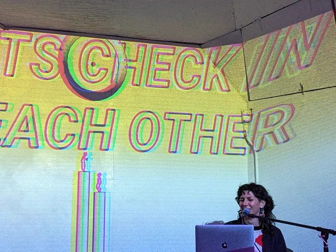 Sarah Rothberg, with a projection of their project "New Meetings"
