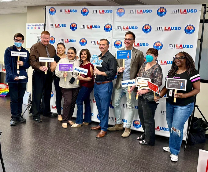 Group photo of a department team in front of ITI LAUSD banner.