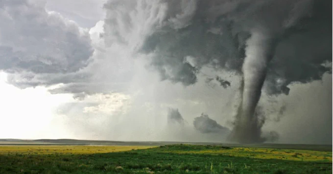 An image of a tornado in a field.