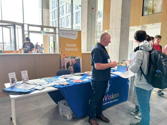The ChildVision stand, with Ray talking to visitors. 