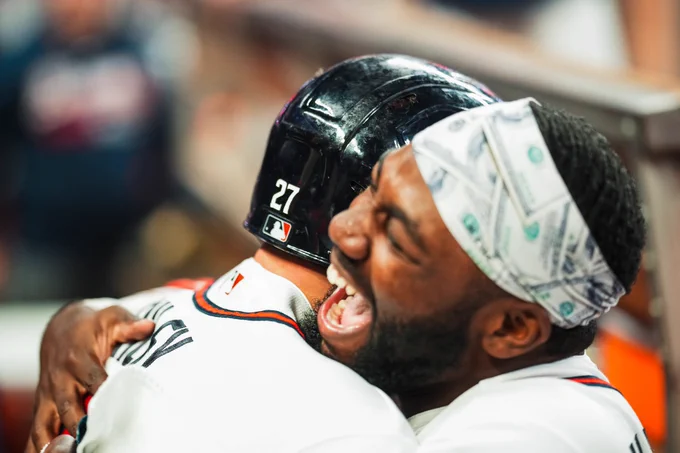 Michael Harris II yells in celebration as he hugs Austin Riley. 