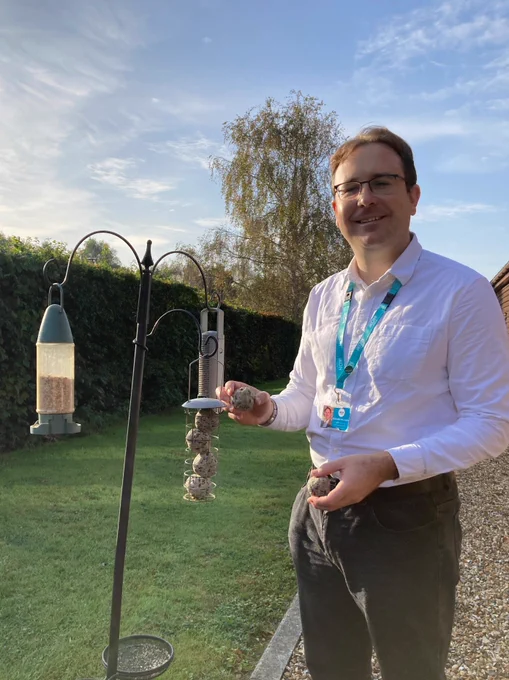 Richard smiling whilst he fills up the bird feeder with fat balls! 