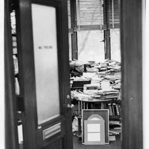 Detail, professor Paul Freund sitting at his desk in Langdell Hall, viewed through his open office door, 1980s. HOLLIS olvwork363278.
