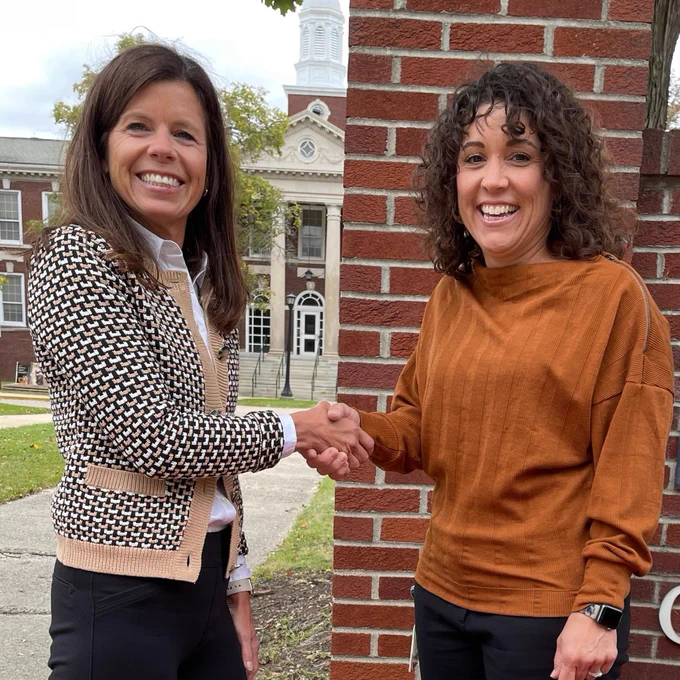 American Heart Association West Michigan Executive Director Jana Siminski, left, delivers three CPR Anywhere training kits to Kim Baron, Grand Rapids Public Schools, right, outside the district's administration building. 