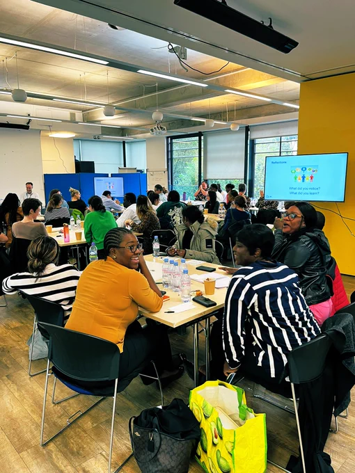 A photo of a training room of approx 50 people smiling and laughing