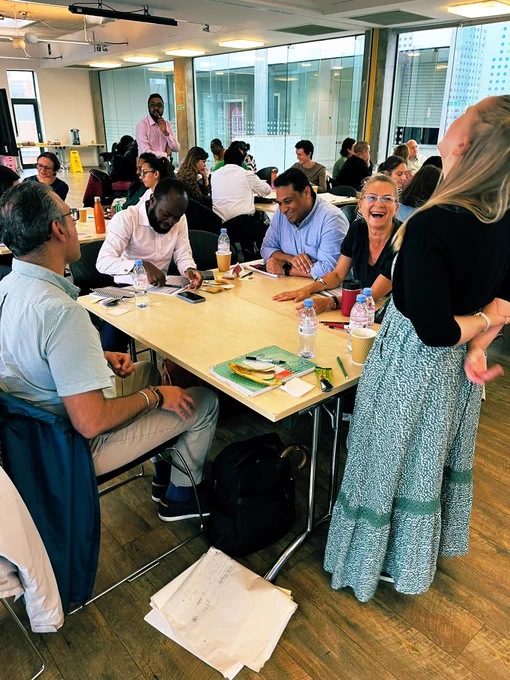 A photo of people at a training course laughing