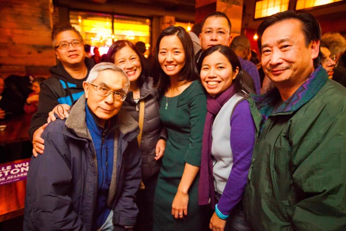 Mayor Wu and a group of community members join Frank Chin for a photo, they all smile.
