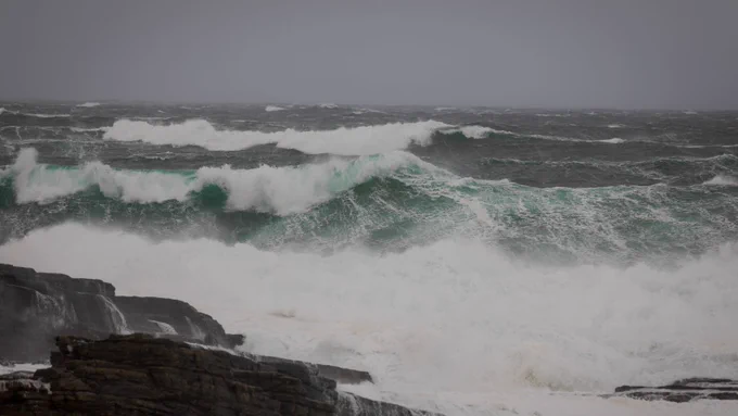 Stormy seas in Orkney with large waves rolling ashore. 