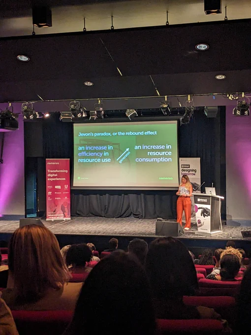 Emily on stage at Interact London. Content on screen explained in tweet