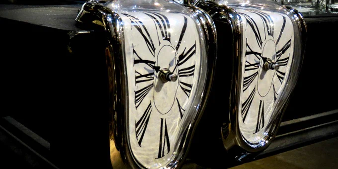 Photo of two melting clocks in the style of Salvator Dali's 'The Persistence of Memory' painting. Credit: Bennilover on Flickr