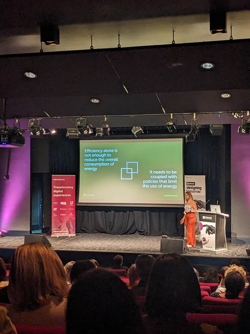 Emily on stage at Interact London. Content on screen explained in tweet