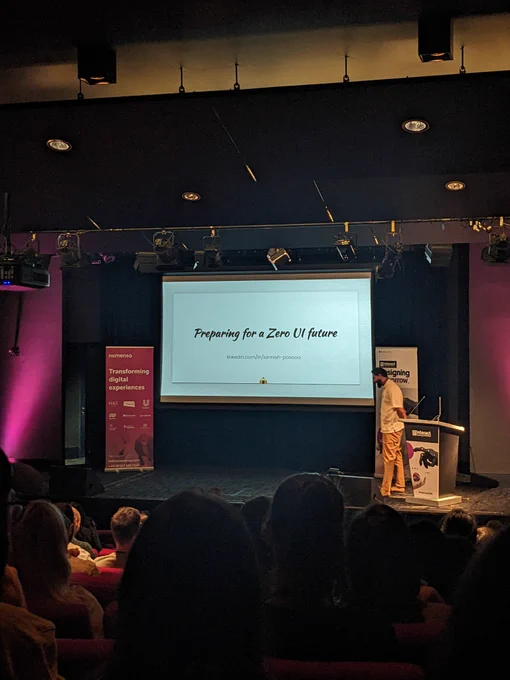 Iannish on stage at Interact London. Talk title provided in tweet