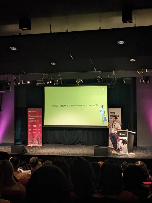 Doron on stage at Interact London. Content of screen discussed in tweet