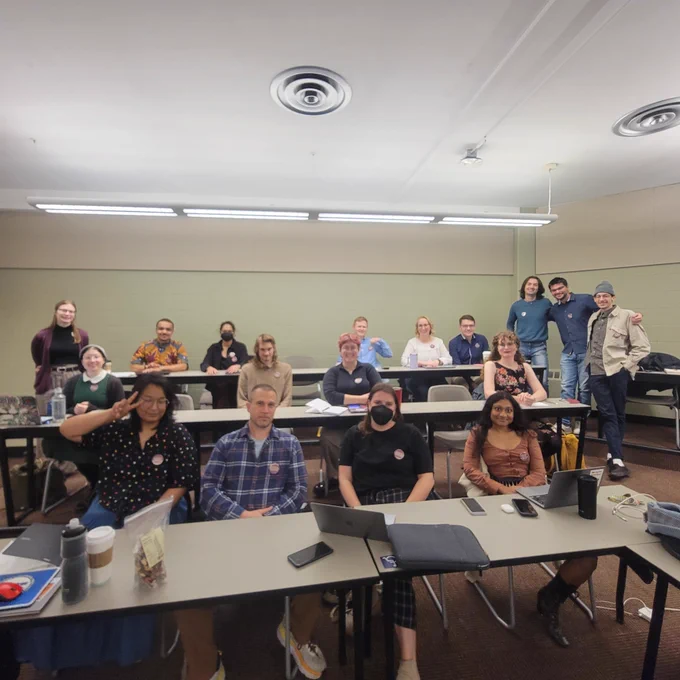 A subset of bargaining committee of about 15 people together wearing buttons to support non-economic contract language proposals