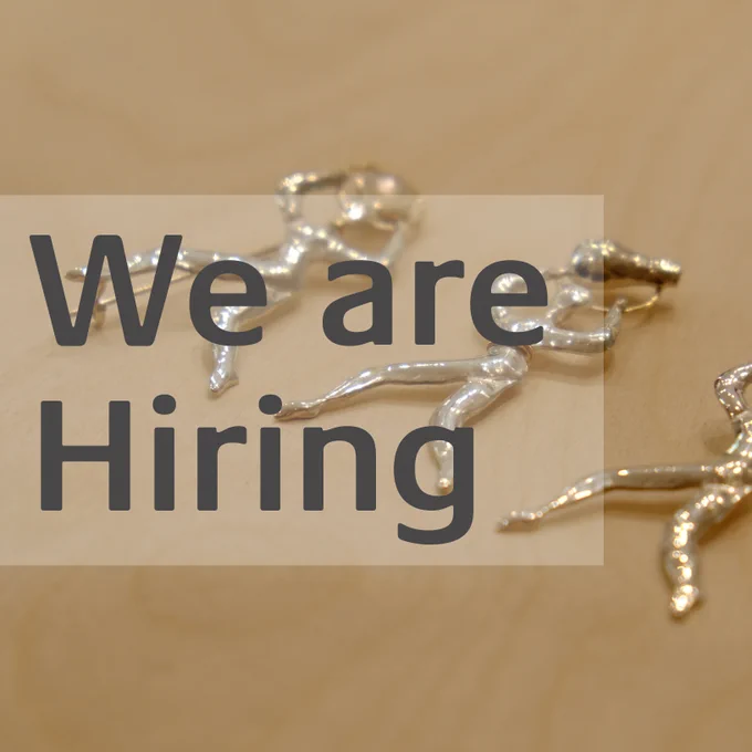 Grey text reads We are Hiring over a photograph of three metal jewellery figures