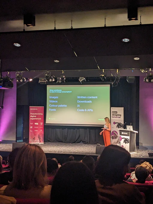 Emily on stage at Interact London. Content on screen explained in tweet