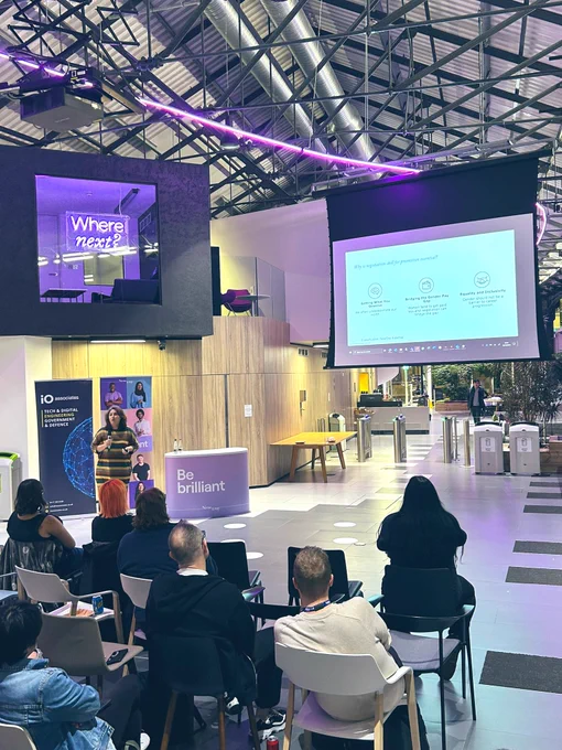 Elham speaking in front of the screen