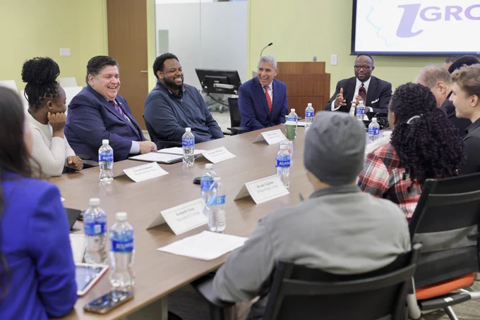 Governor Pritzker laughs with the roundtable discussion participants.