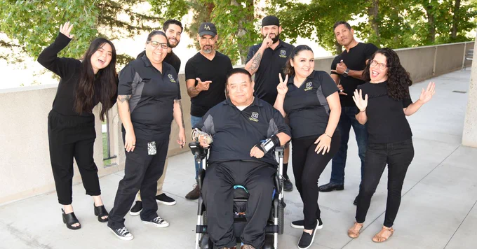 A group of people smiling and posing for a picture.