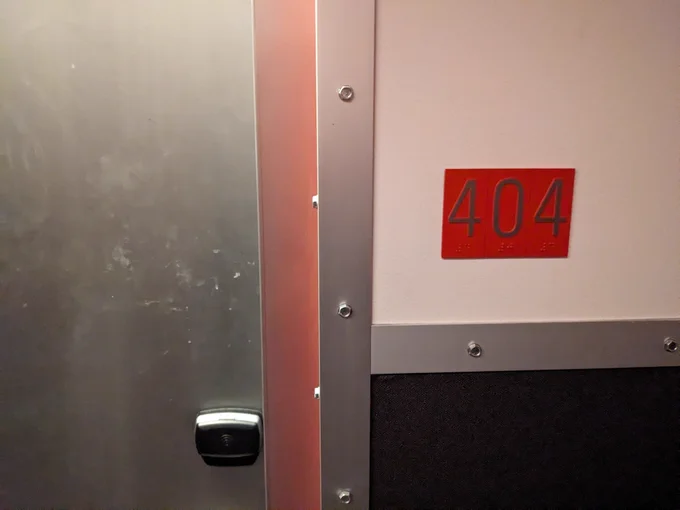 An image of a door of a hotel room. The room number is 404.