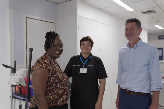Image shows two NHS England colleagues standing with a member of staff from Imperial College Healthcare.