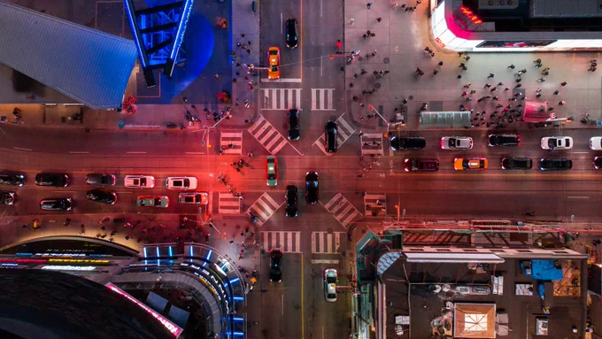 An aerial of traffic at the intersection at Yonge and Dundas streets in Toronto at night.