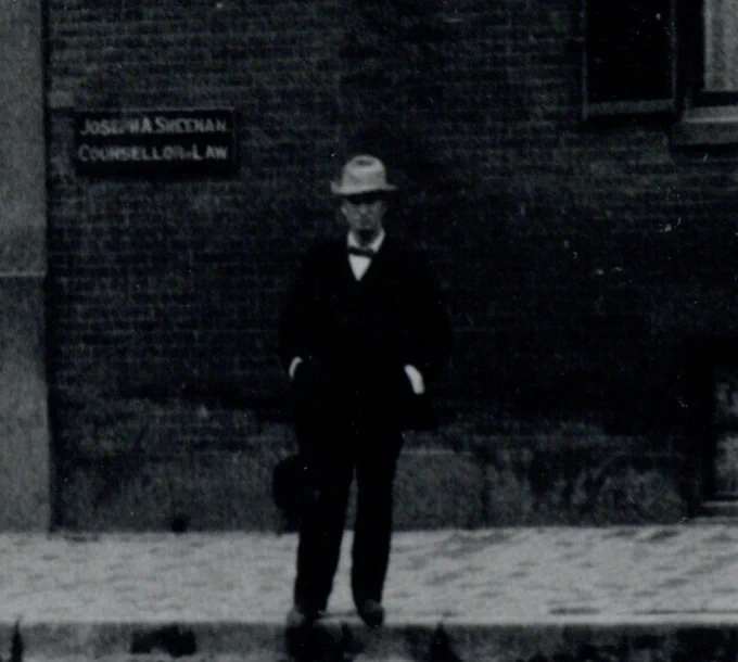 Close up of a man on the street wearing a hat