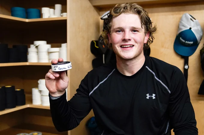 Barracuda forward Ethan Cardwell poses with his first American Hockey League goal puck