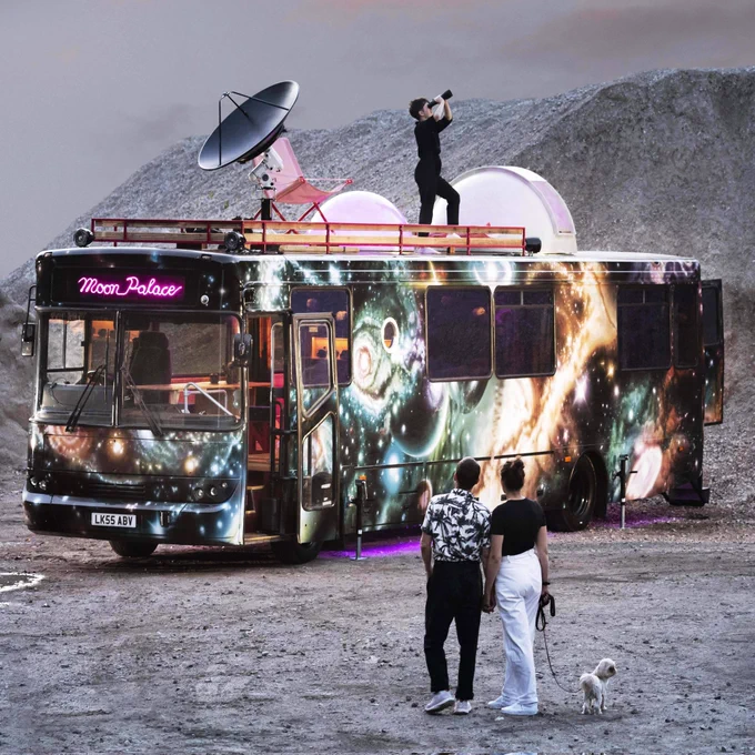The moon Palace Mobile observatory bus parked in a lunar landscape 