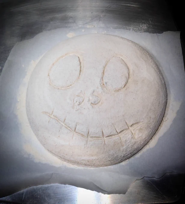 Sourdough bread scored with a Halloween face 