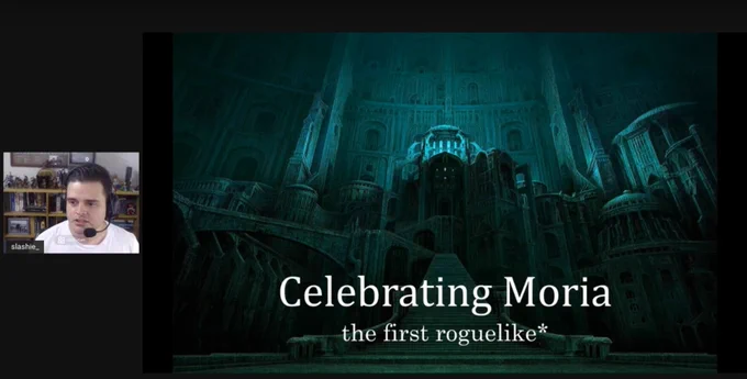 A screenshot of a previous year's talk. Slashie is on the left and small, and the title slide is large on the right. It says "Celebrating Moria, the first roguelike*".