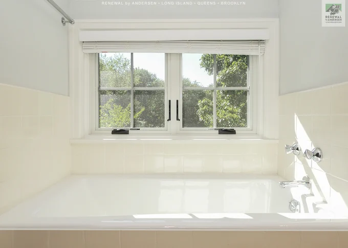 Pretty bathroom with new windows we installed. This unique bathroom in a loft style space looks superb with farmhouse style casement windows over the bathtub. Get started replacing the windows in your home with Renewal by Andersen of Long Island, serving Suffolk, Nassau, Queens and Brooklyn.