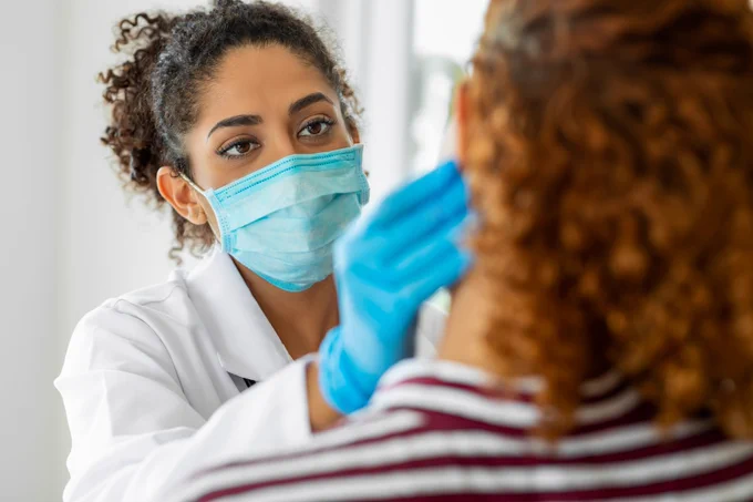 Dentist examining patient.