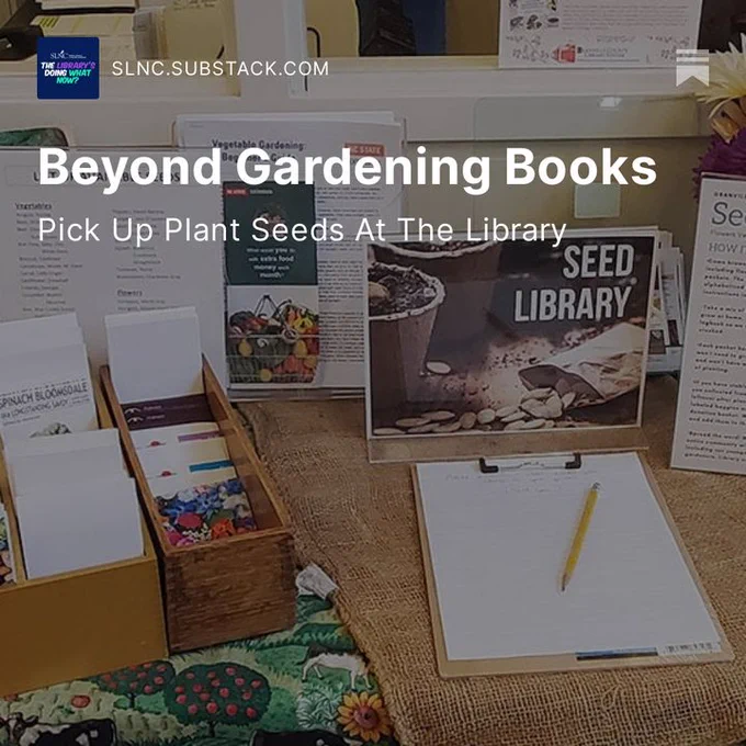Image of the seed library set up at the Granville Co. Library's South Branch Library. Consists of a small display about local seeds including plant information and seed packets. " title="Seed library set up at the South Branch Library. Consists of a small display about local seeds including plant information and seed packets. "  Overlay of white text that says, Beyond Gardening Books: Pick up Plant Seeds At the Library.