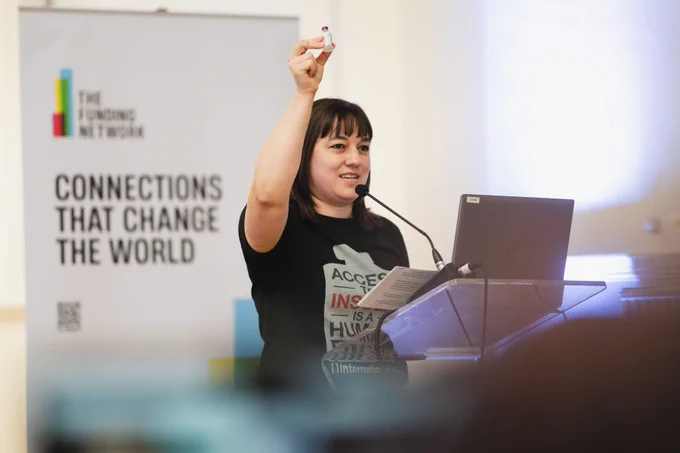 T1International Founder & Executive Director, Elizabeth, holding up a vial of insulin during her live pitch to The Funding Network