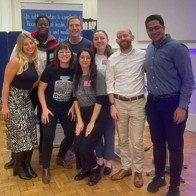 the T1I team and supporters standing together.