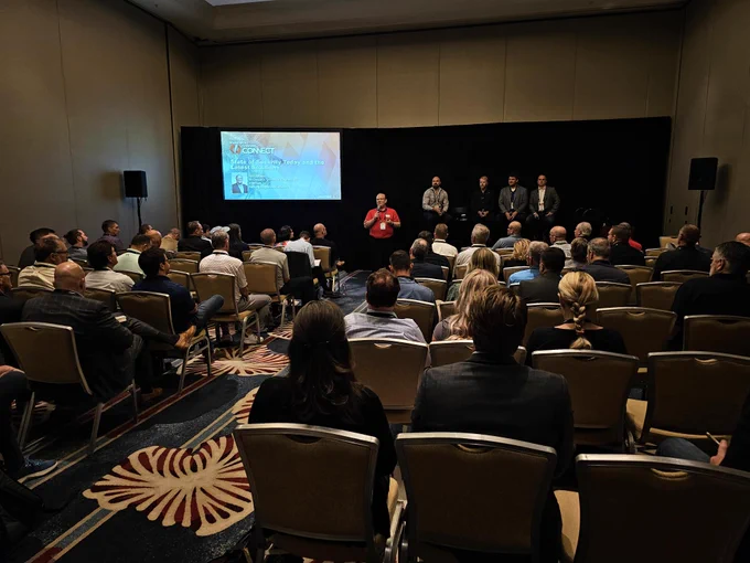 A panel of subject matter experts discuss cybersecurity in front of an audience 