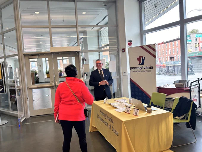 Secretary Schmidt speaks with a voter at South Philadelphia Library.