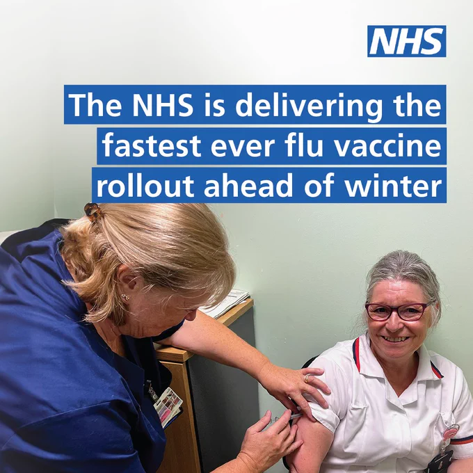 Text: The NHS is delivering the fastest ever flu vaccine rollout ahead of winter. Image: A staff member wearing a white uniform is receiving a flu vaccine being administered by a nurse. The staff member receiving the vaccine is sitting down and smiling.
