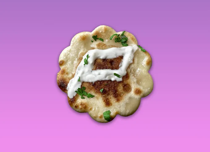 a Panic logo shaped pierogi with a "P" drawn in sour cream