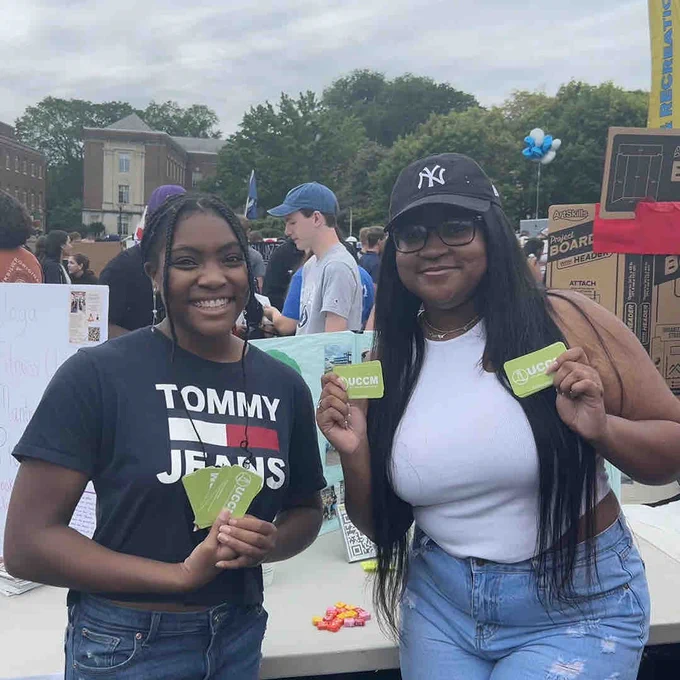 Cameryn Allen (right) and Gabriella Achampong (left), both executive committee members of Unity Christian Campus Ministry, participate in the Involvement Fair at Penn State earlier this fall.