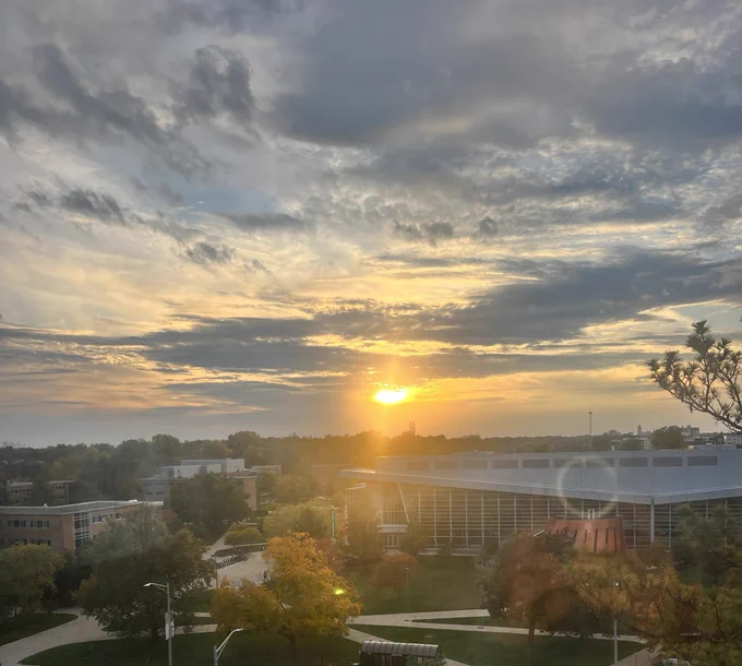 View of the sun over a building.