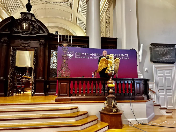 A photo of German Ambassador Andrea Michaelis standing on stage at a podium.