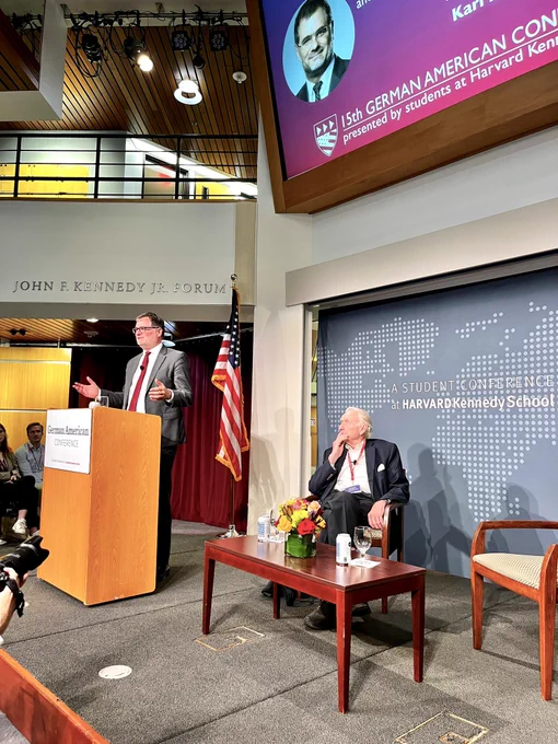 Wolfgang Schmidt giving a speech at a podium on a raised stage