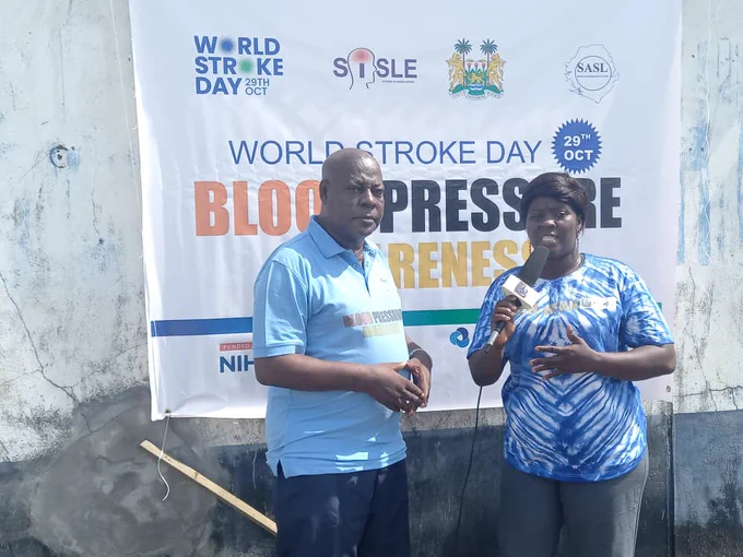President of the Stroke Association of Sierra Leone being interviewed by a journalist 
