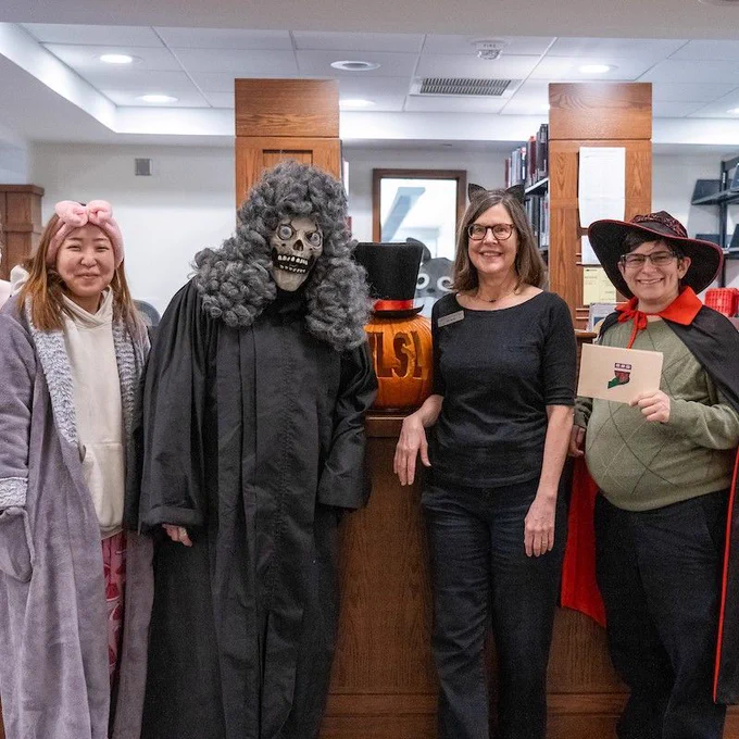 The tour cast gathers at the Circulation Desk after the final tour. 