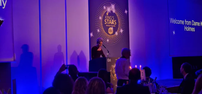 Image of the King’s Stars stage with Clive Kay and presenter, Double Olympic Champion, Dame Kelly Holmes, introducing the event.