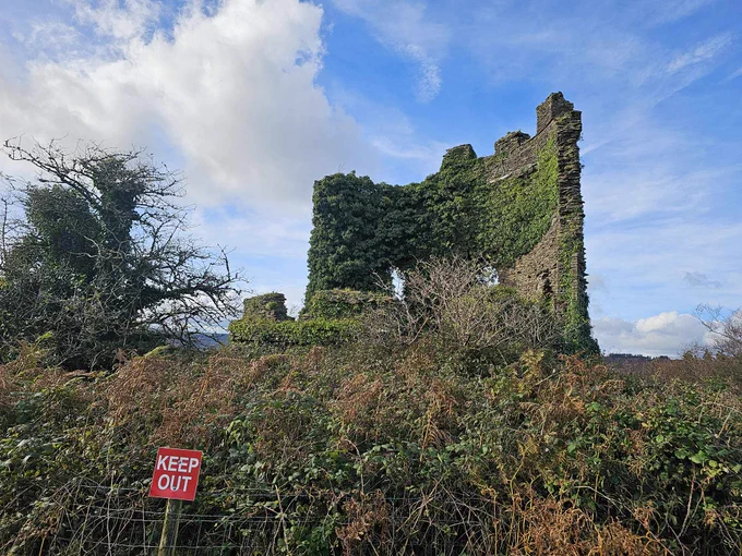 Ivy tower with a keep out sign in front.