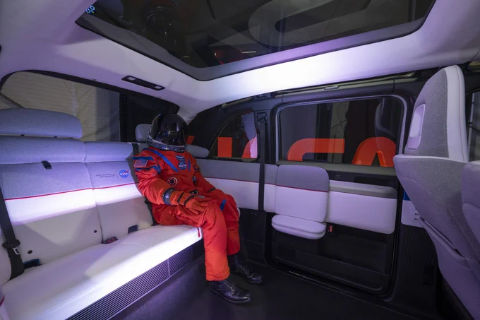 A futuristic interior of a vehicle is shown, with black floors and white seats. In the spacious back sits "Campos", a manikin in an orange Artemis flight suit. Campos flew aboard the Orion spacecraft during the Artemis I mission in order to collect important data that will prepare astronauts for future Artemis missions.
Photo Credit: (NASA/Robert Markowitz)